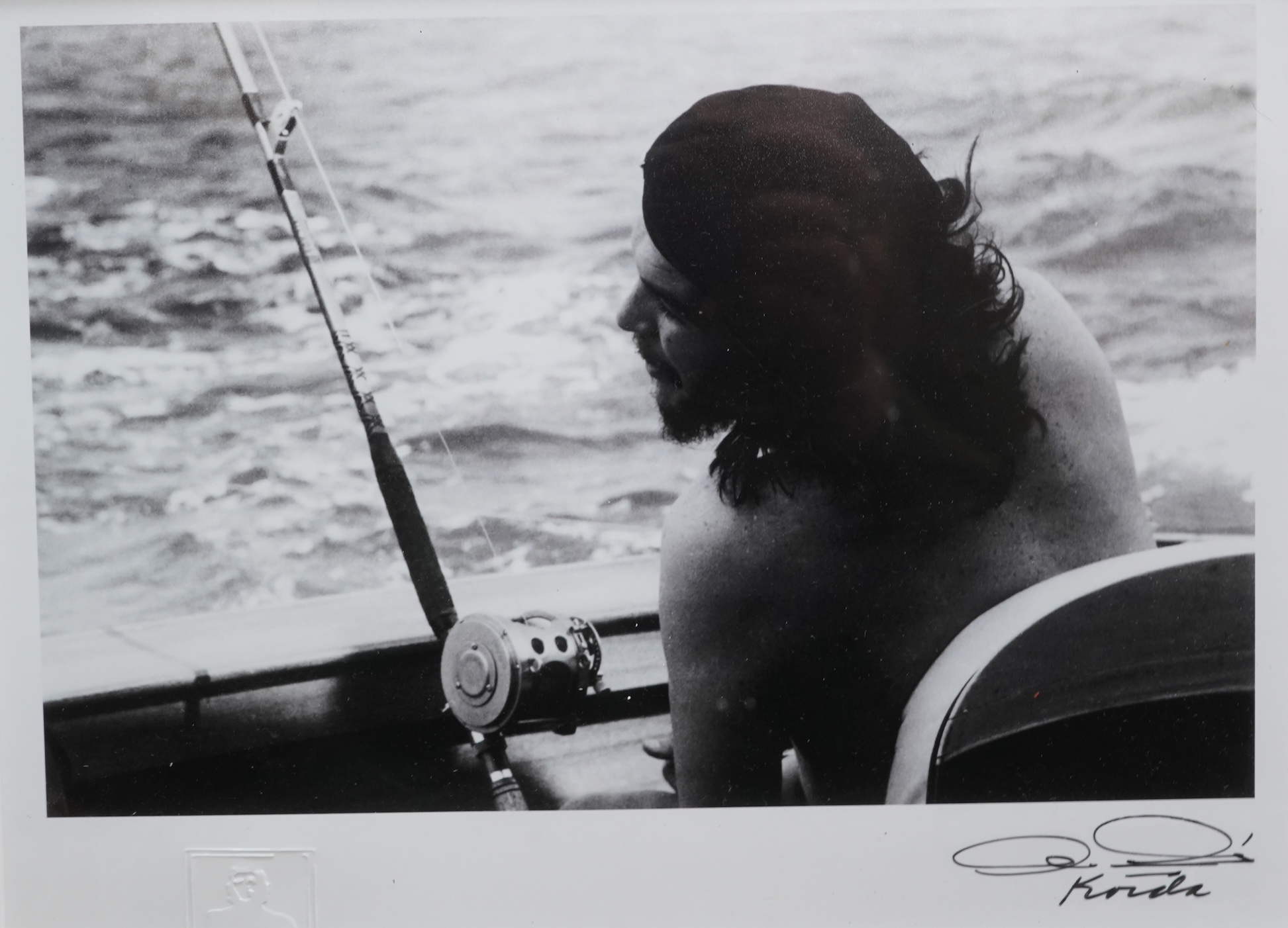 After Alberto Korda (1928-2001), ‘Che Guevara fishing’, stamped, facsimile signature, gelatin silver print, 20 x 26cm